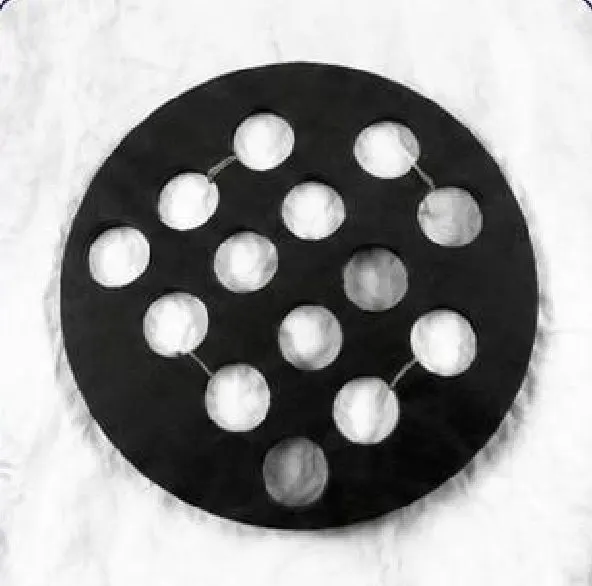 Round black perforated rubber gasket with a pattern of holes